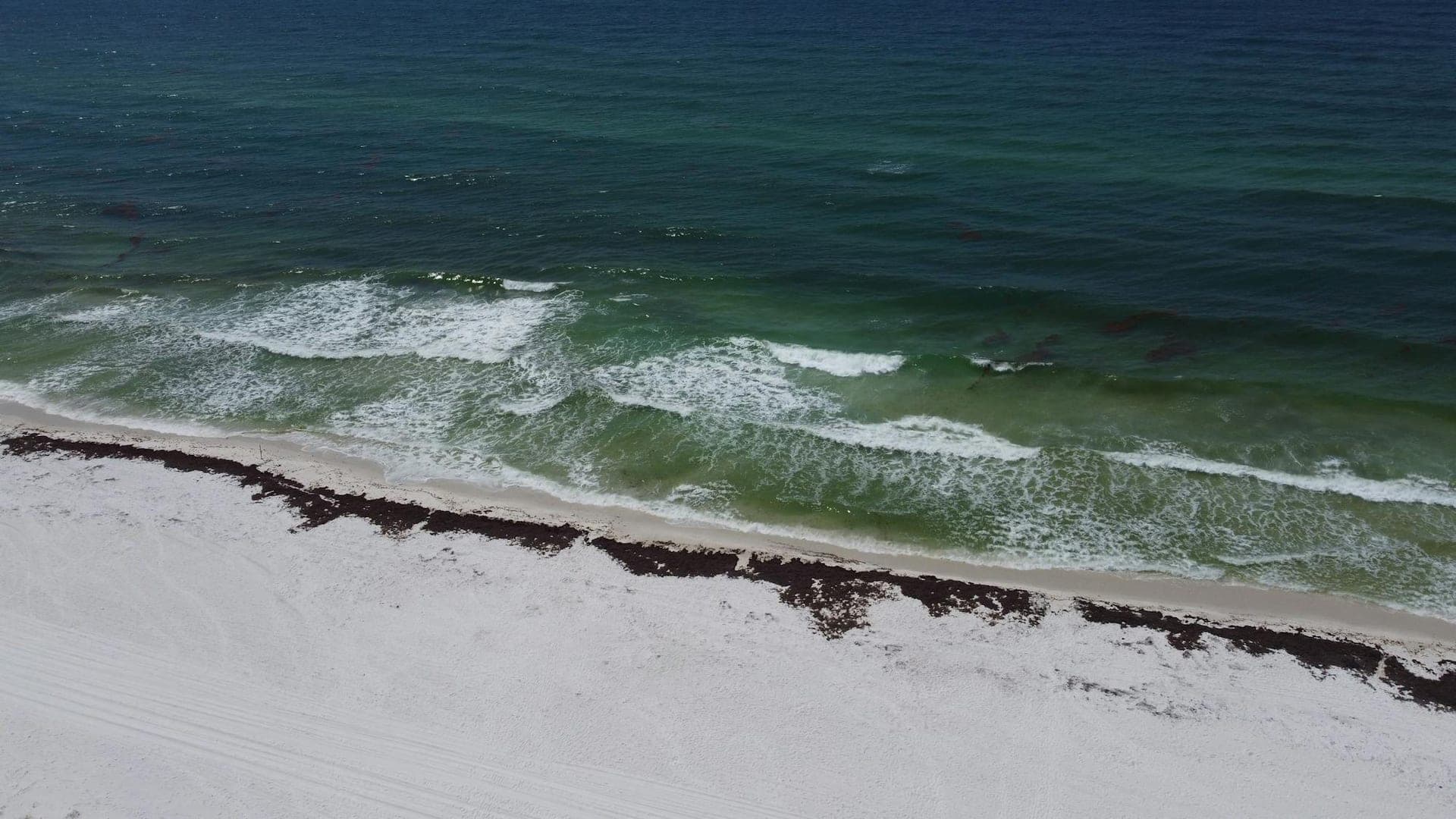 Aerial view of the Gulf-side shoreline along Florida's Emerald Coast near Navarre Beach.